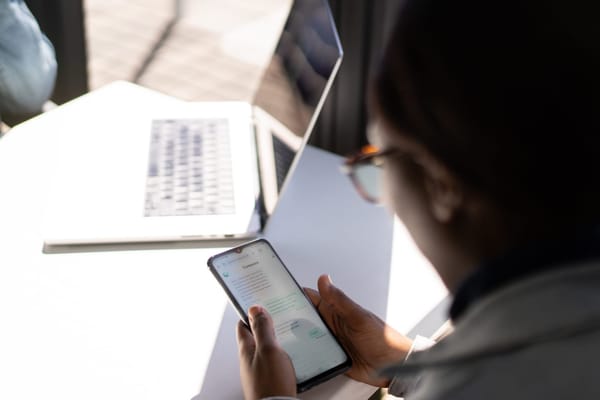 A user testing using a smartphone to interact with an AI-enabled chatbot.